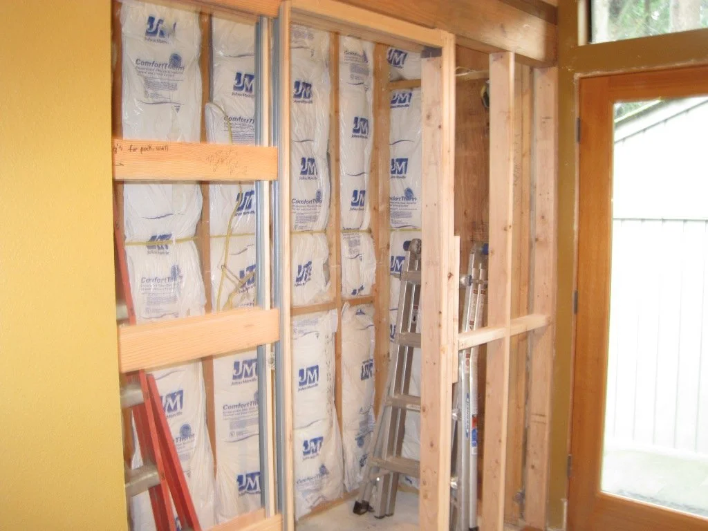 New half bath with pocket door at the other end of the hous. We suspected this area was an earlier addition. The insulation gave it away. It is newer than insulation found in other areas of the house.