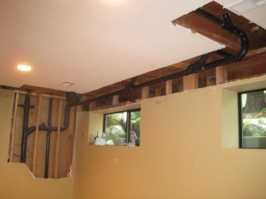 Below the Master Bath work in a play room in the basement. Sometimes you have to tear into adjacent rooms to get work done. Adds a little cost to repair the sheetrock and refinish the room.