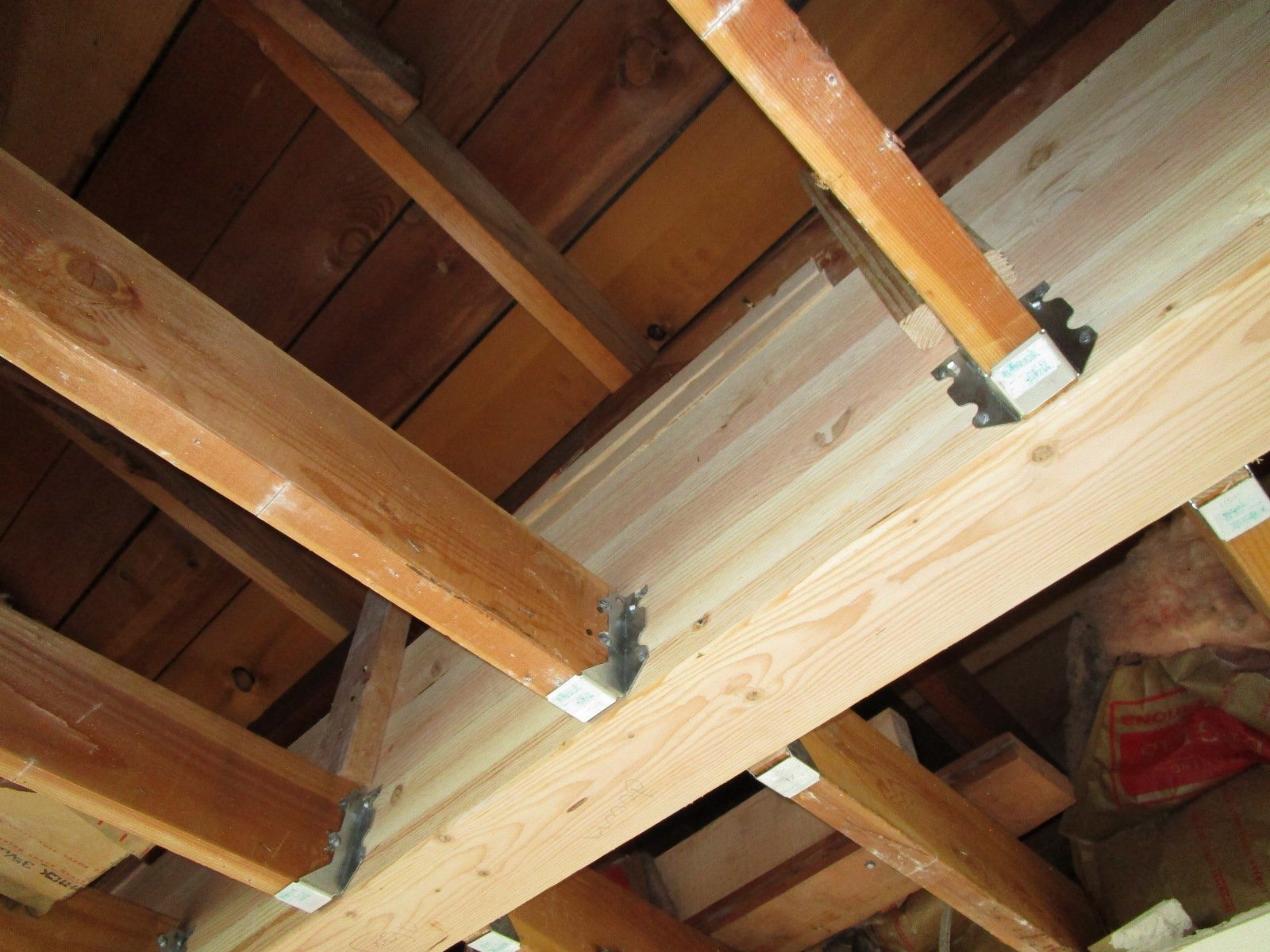 Ceiling joists get hung to the sides of the new glu lam beam.