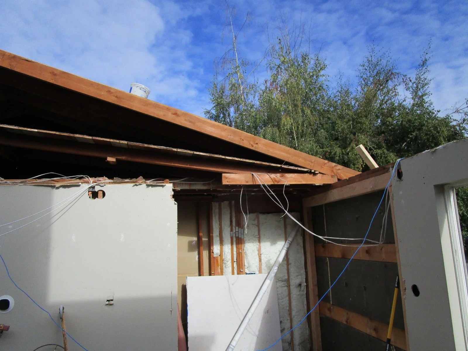 These old roof pieces need to be removed carefully due to electrical and other utilities strung in the attic.