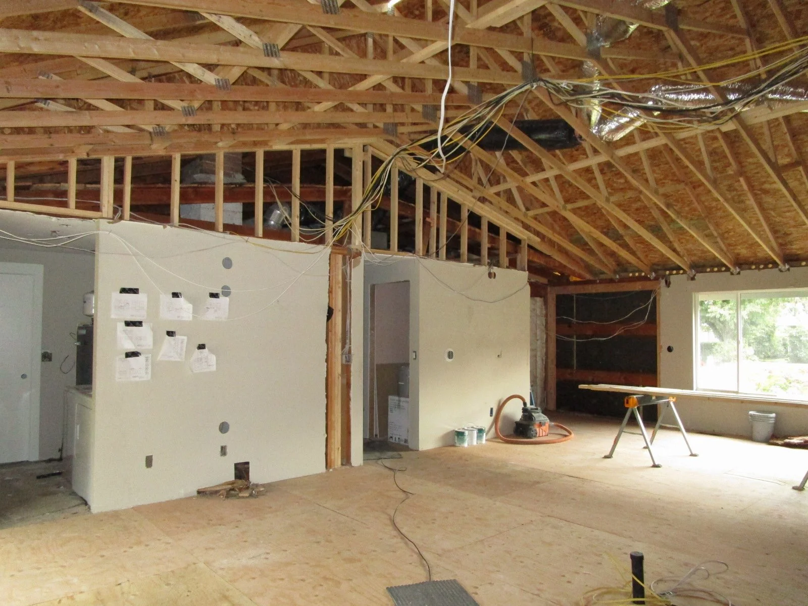 Looking from the kitchen area up to the entry (in black)