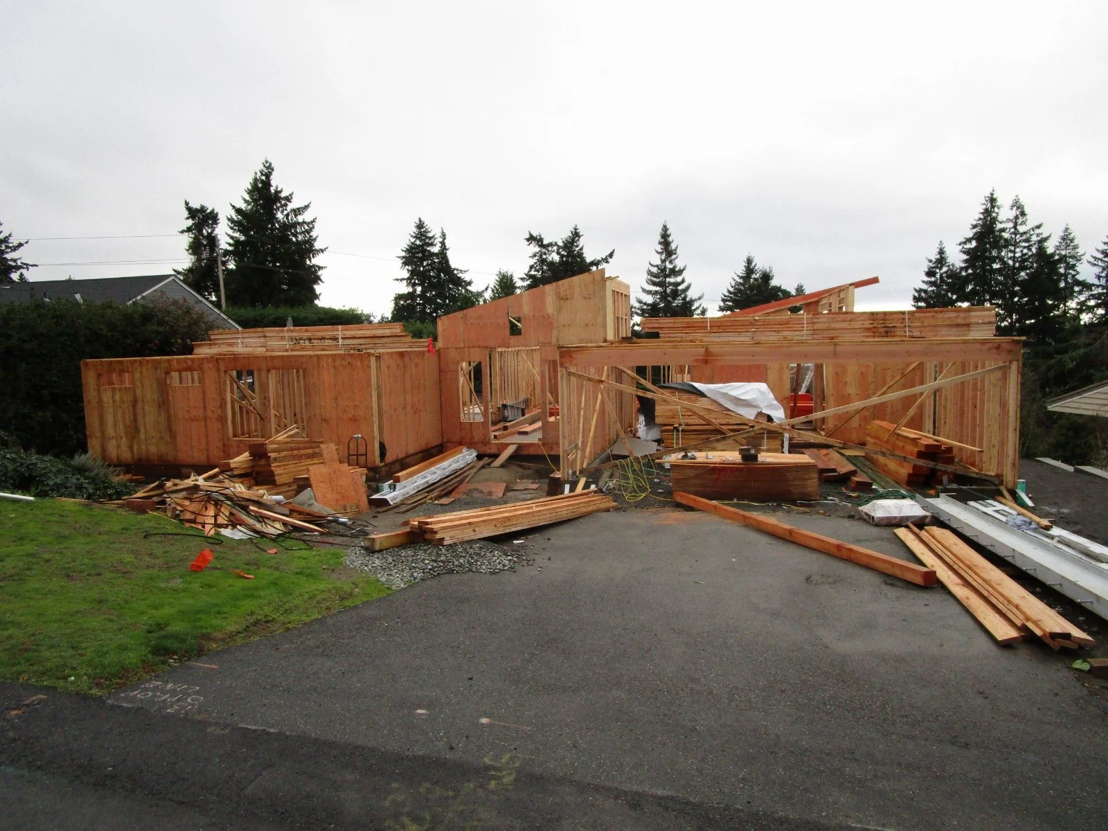 From the street, trusses have been delivered. The roof is about 50% trusses, 50% hand built stick framing.