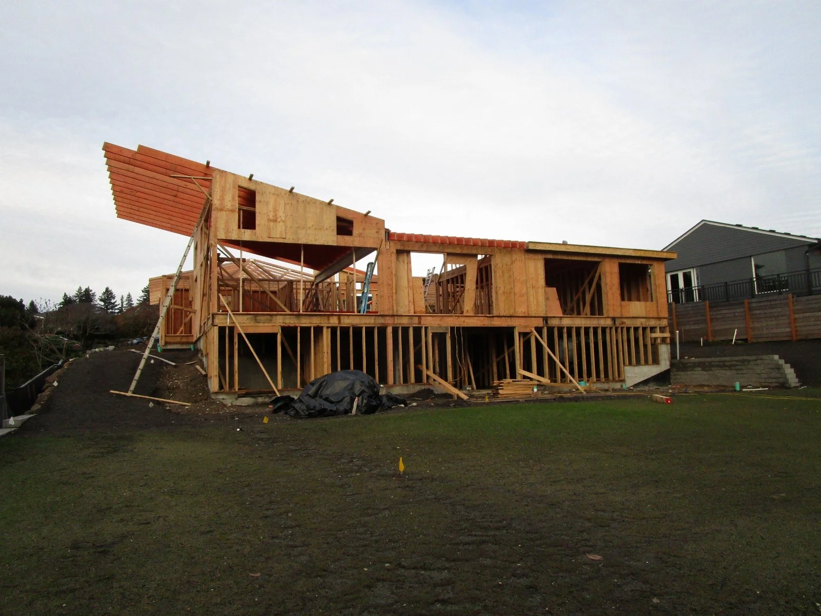 View from the backyard. Big roof cantilever on the left will get trimmed back to about the first rafter.