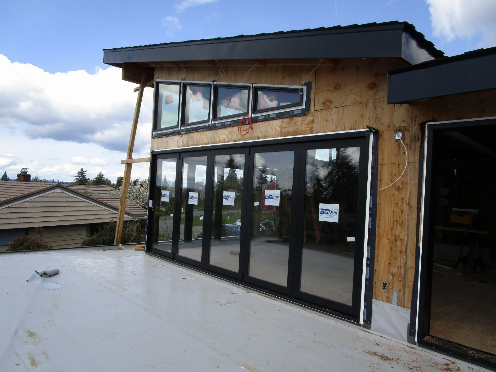 Up on the deck, doors and transom windows to the dining/kitchen area inside.