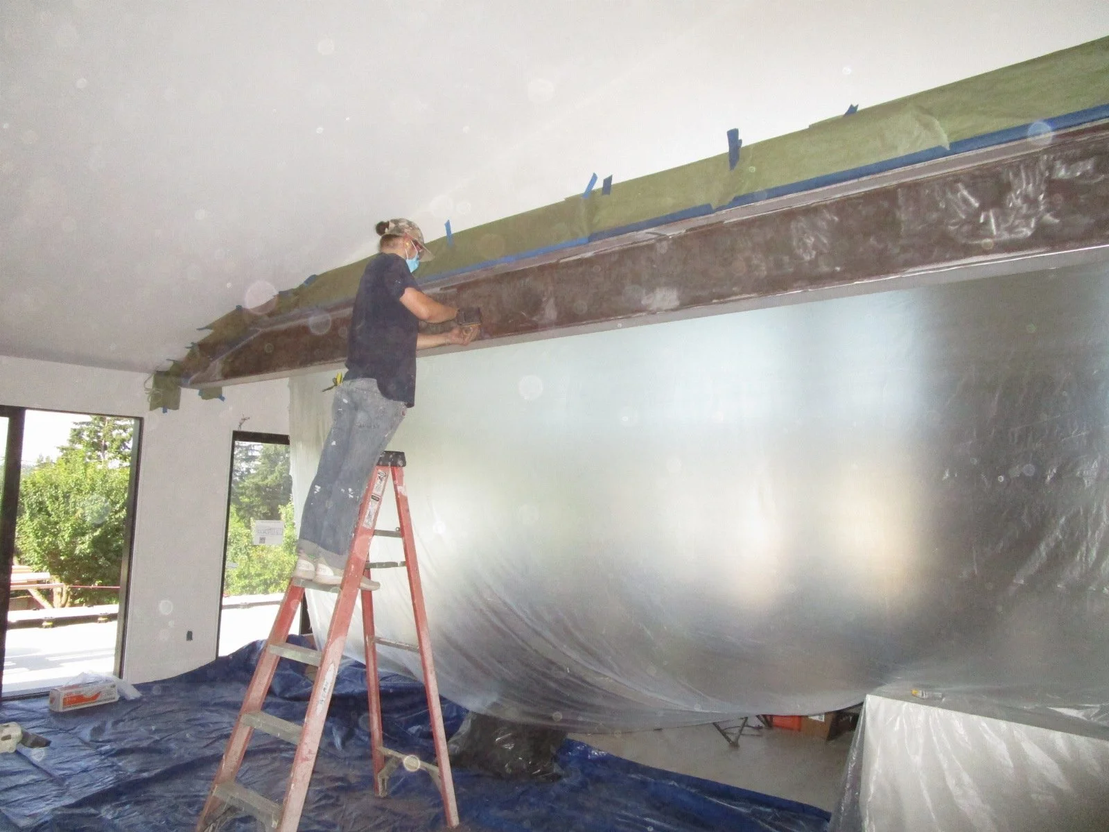 Inside, the steel beam is getting prepped for finishing.