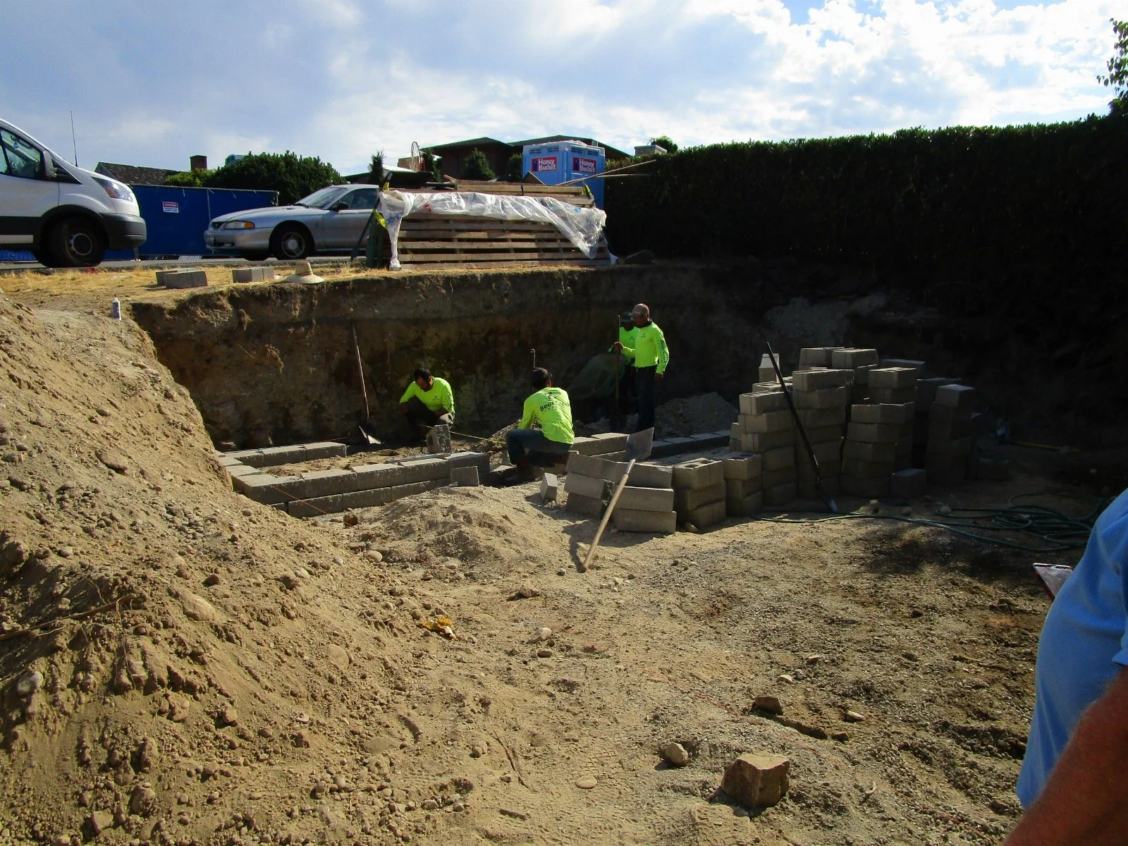 Landscapers are setting up some planting beds in the front yard.