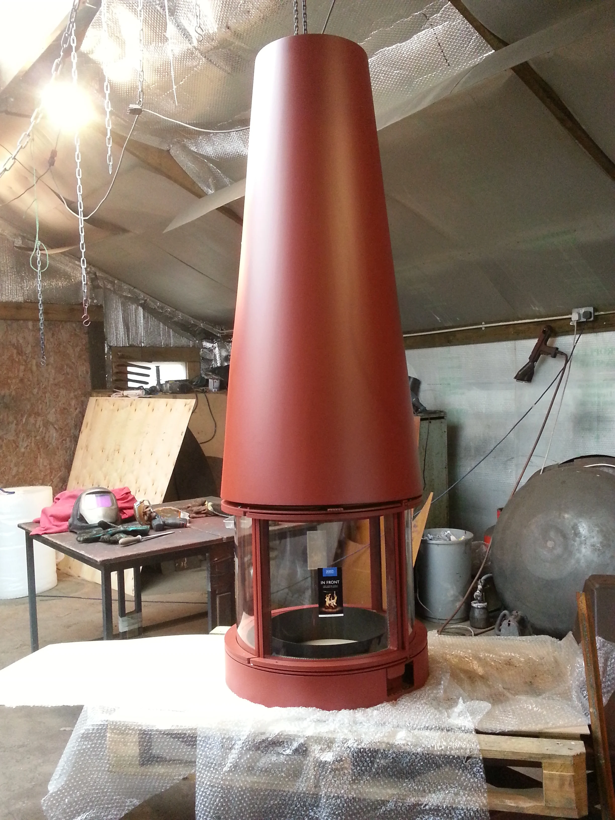 Bespoke high hooded stove-in-the-round