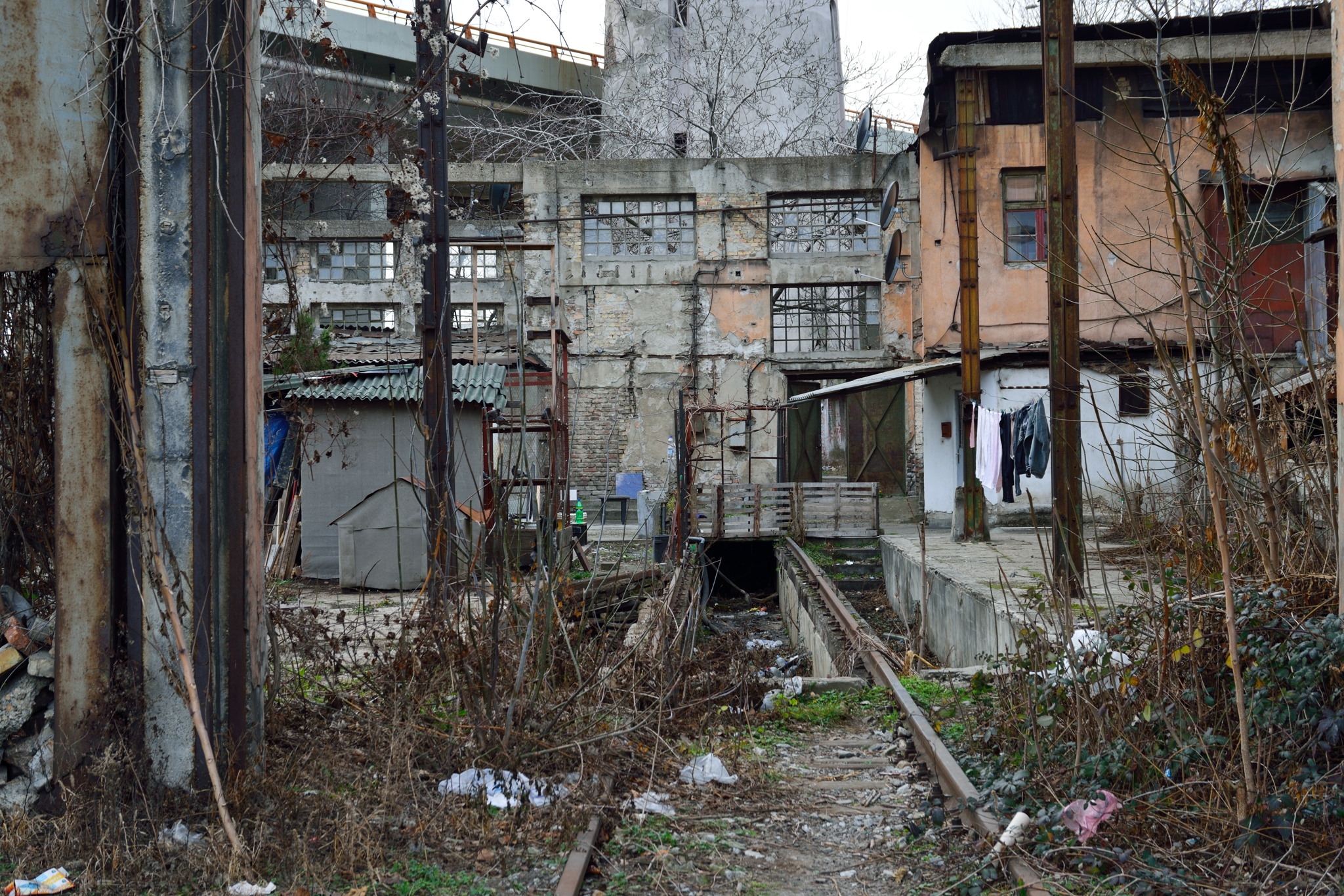 A disused train depot near the Main Railway Station is re-appropriated by homeless and Roma Gypsy. Since Yugoslav breakup in the early '90s saw a steady decline in usage and funding until its planned demolishing in September 2014 when a $3 billion project Beograd na vodi or Belgrade on Water begins largely in due to United Arab Emirates funding. 