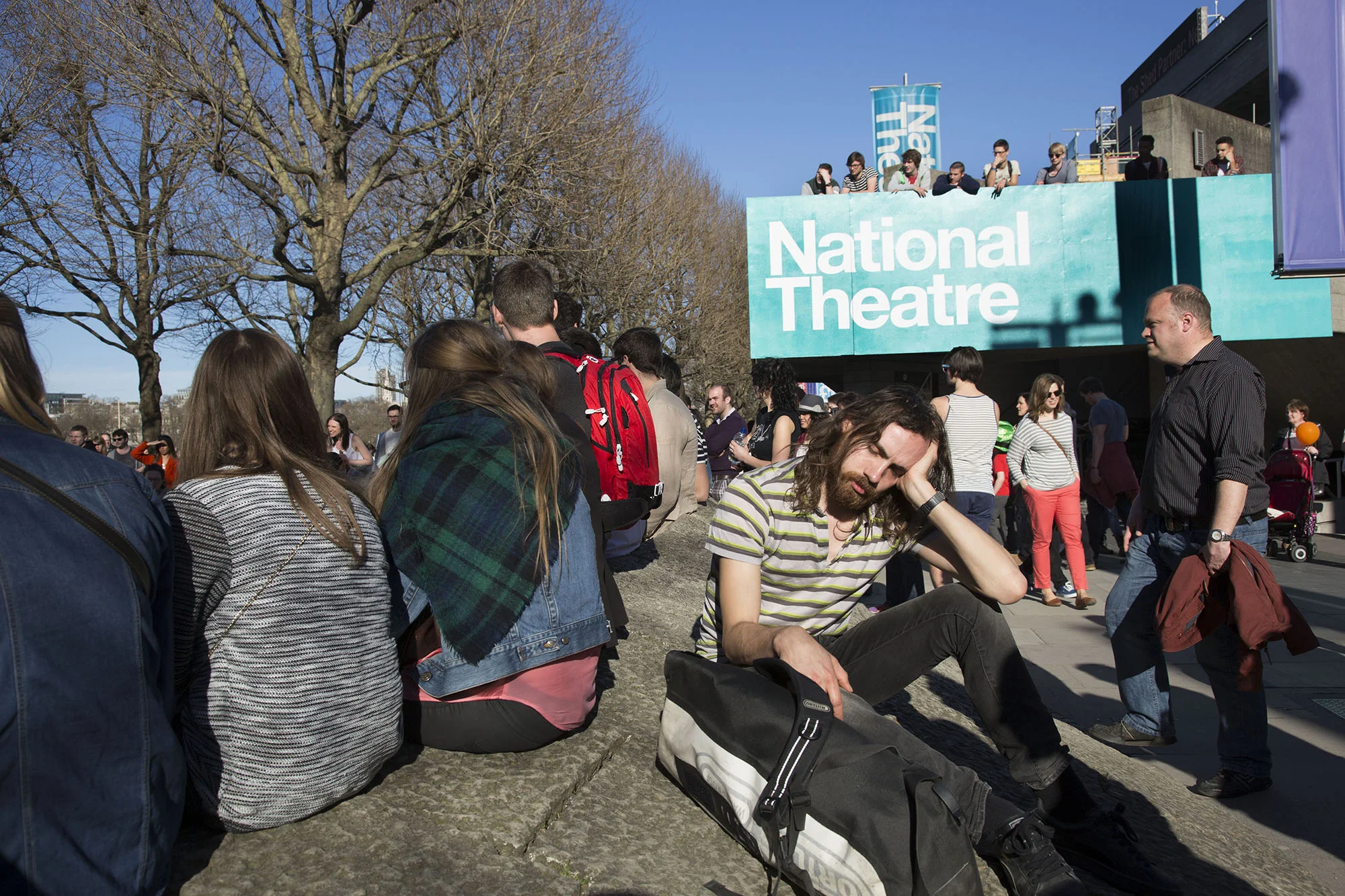 Man having a sleep outside the National Theatre.