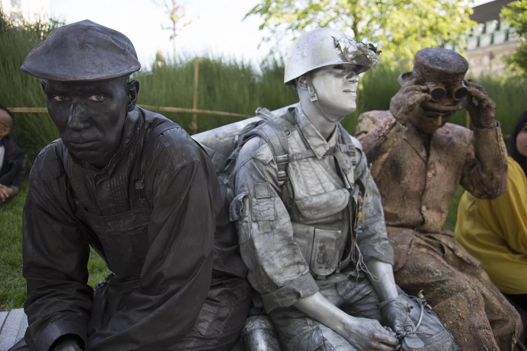 Living statues hang out during a break in standing still.