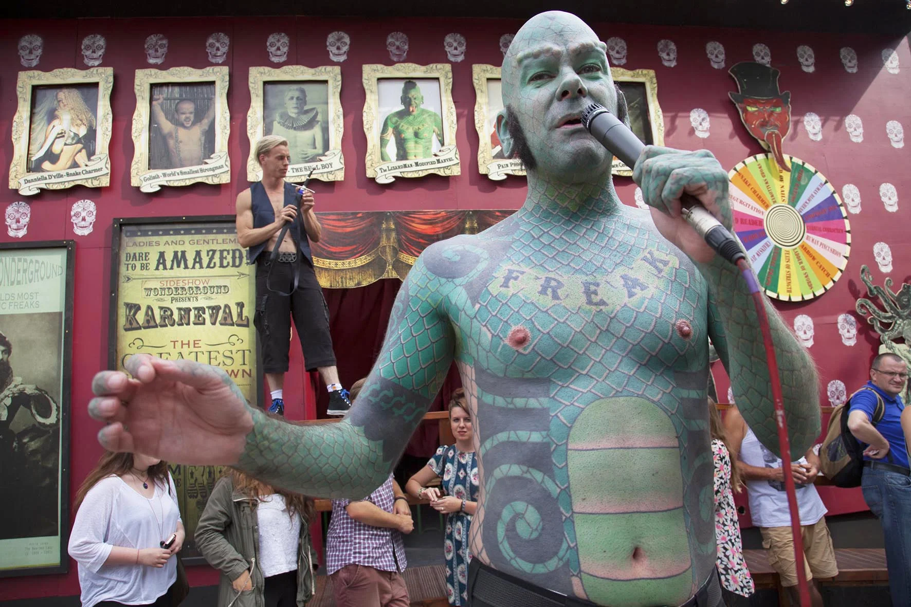 The Lizard Man introduces acts and sells the show 'on the inside' at Wonderground Sideshow freak show.
