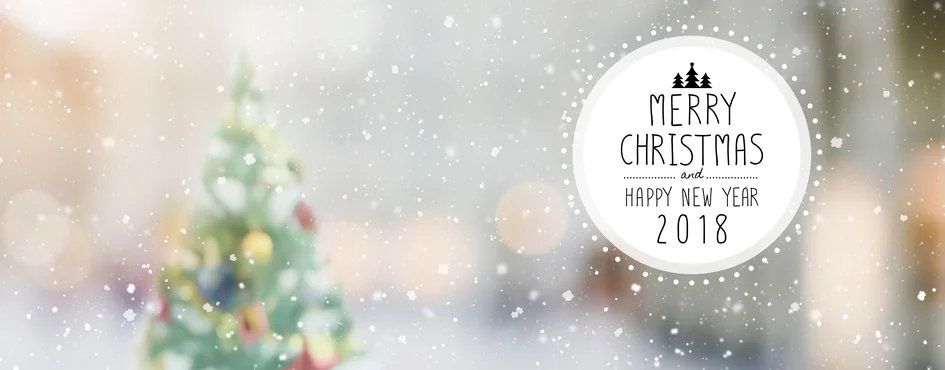 Christmas-and-Happy-new-year-2018-on-blurred-bokeh-christmas-tree-with-snowfall-banner-background-844937178_948x371.jpeg