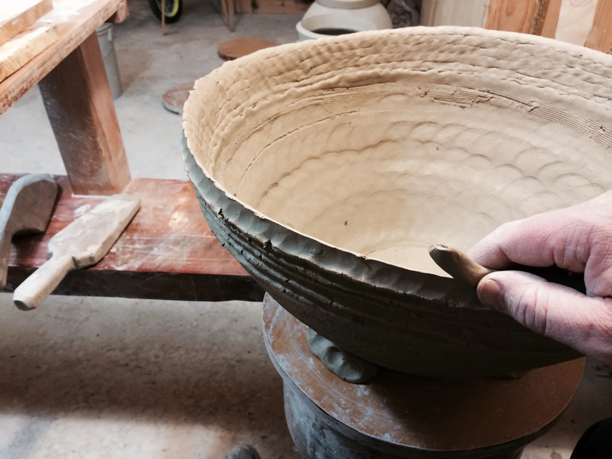 After drying, the form is flipped and coils are added.