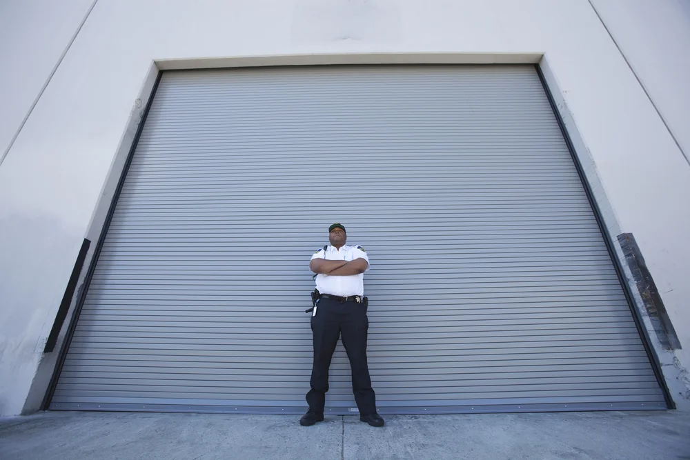 bigstock-Security-guard-standing-with-a-42113896.jpg
