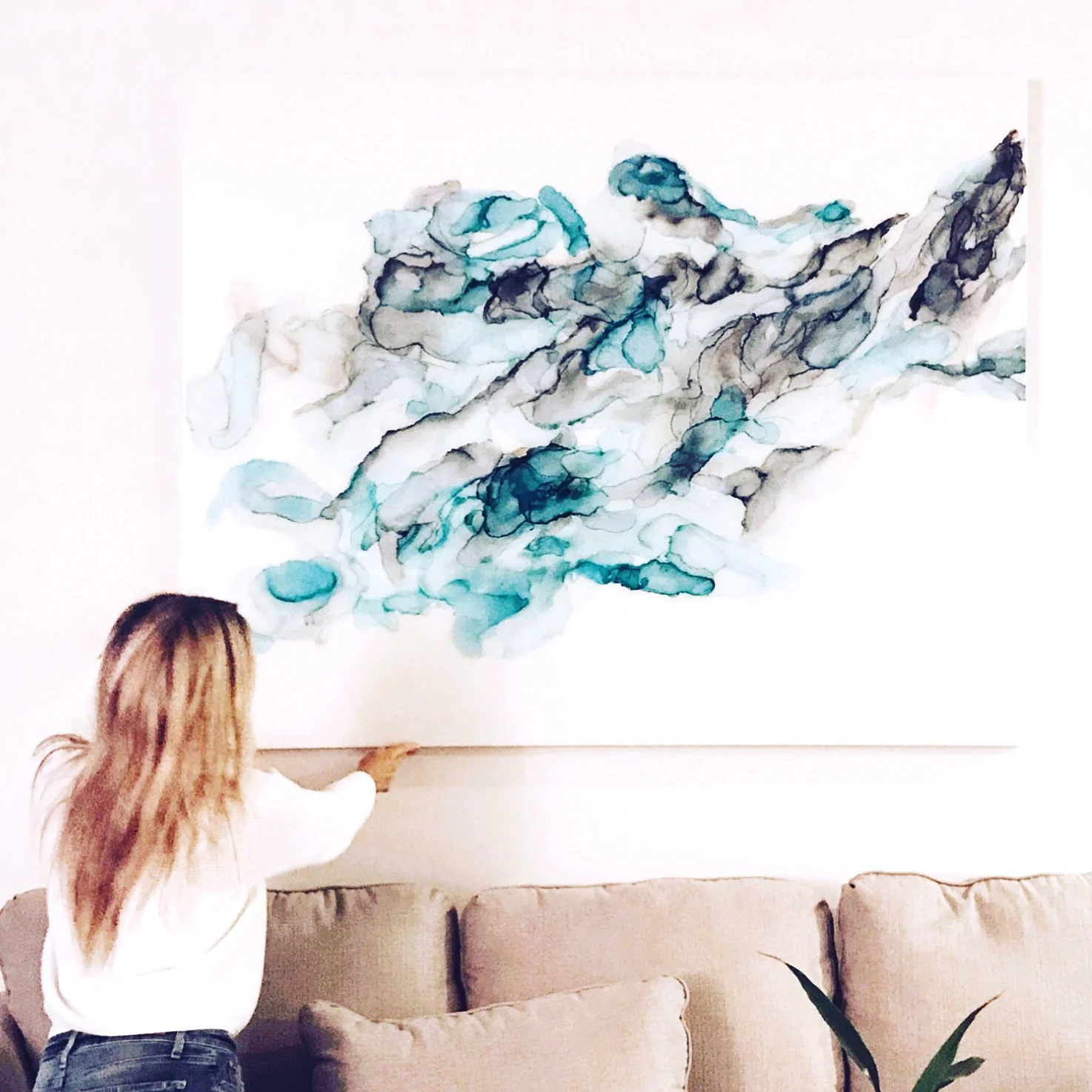 Sherry Michelle installing “Thoughts”, a special order commission in a client’s home 2018 60” x 48” x 2”