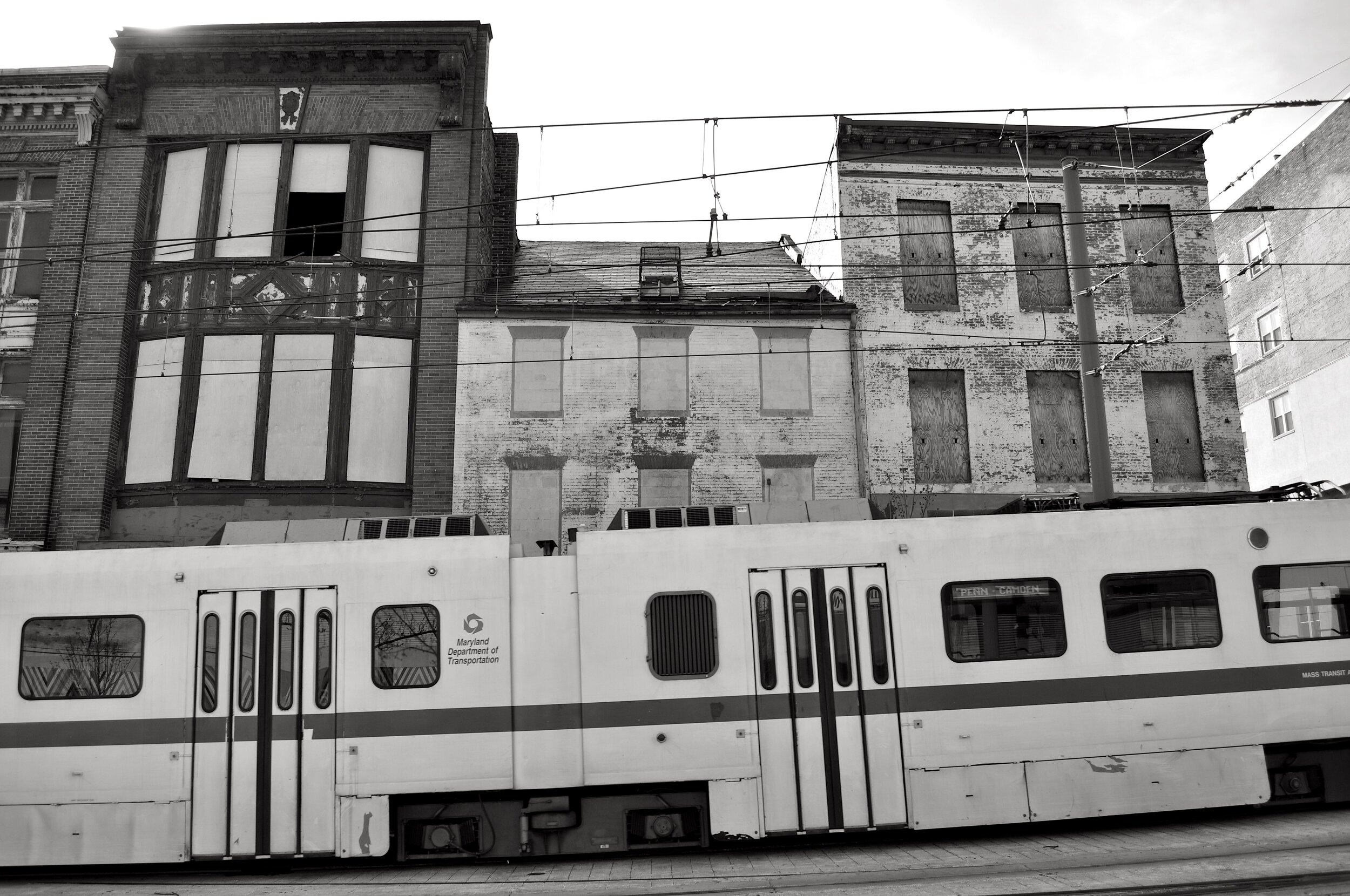 Light Rail Passes Some Abandoned Buildings BW T.JPG