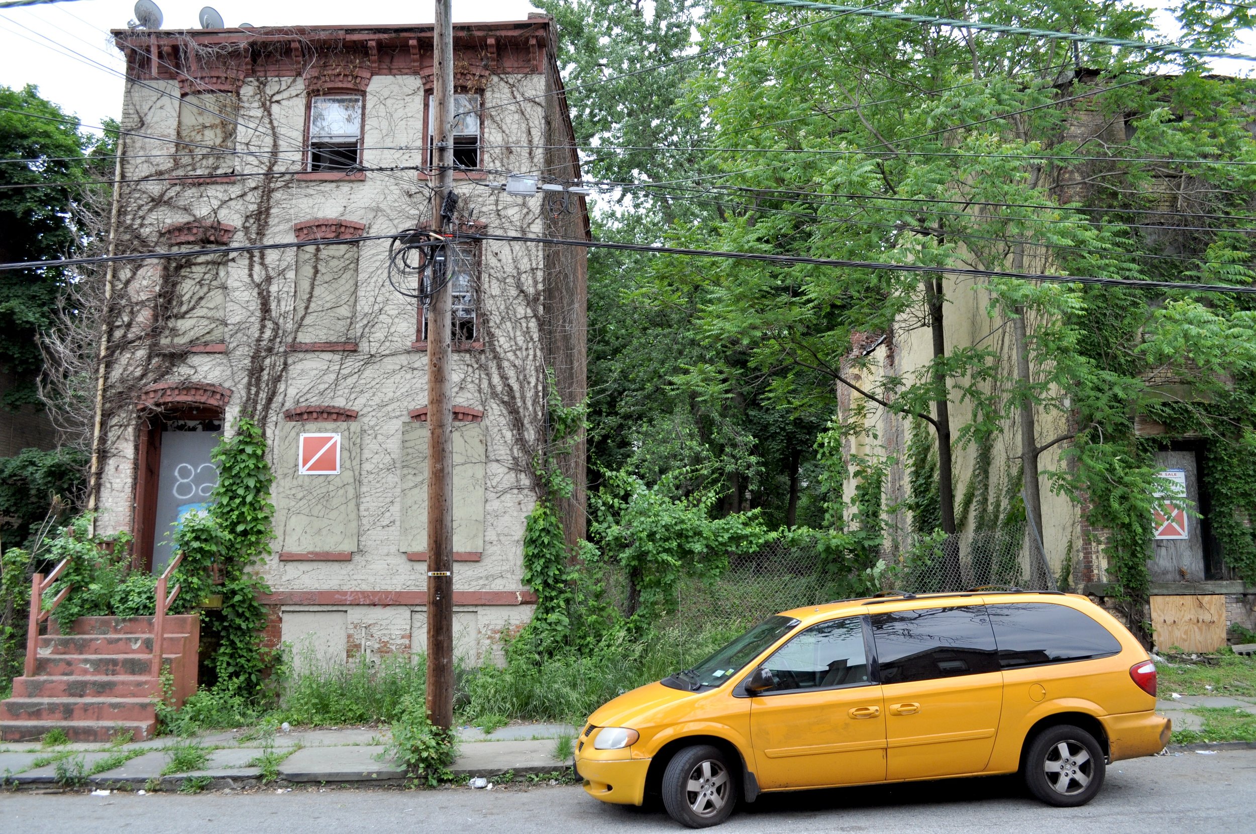 2018 Taxi Van With Abandoned Buildings - Newburgh NY T.JPG