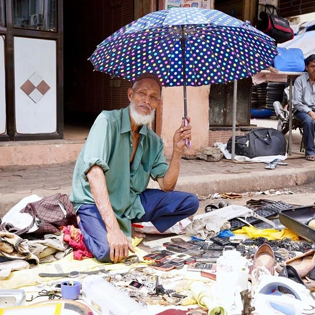 The Chor Bazaar in Mumbai, this is the real India, Taking shelter from the intense heat and sun while trying to sell goods.
#streetphotography #chor #market #bazaar #India #stall #iPhone #streetlife #urbexphotography #umbrella #life