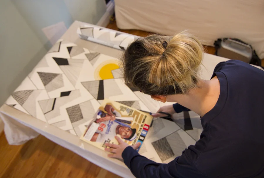 Chloe cutting wallpaper with scissors