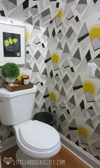 Mountains by MissPrint wallpaper makes this powder room pop.