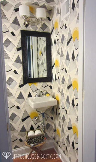 Mountains by MissPrint wallpaper makes this powder room pop.