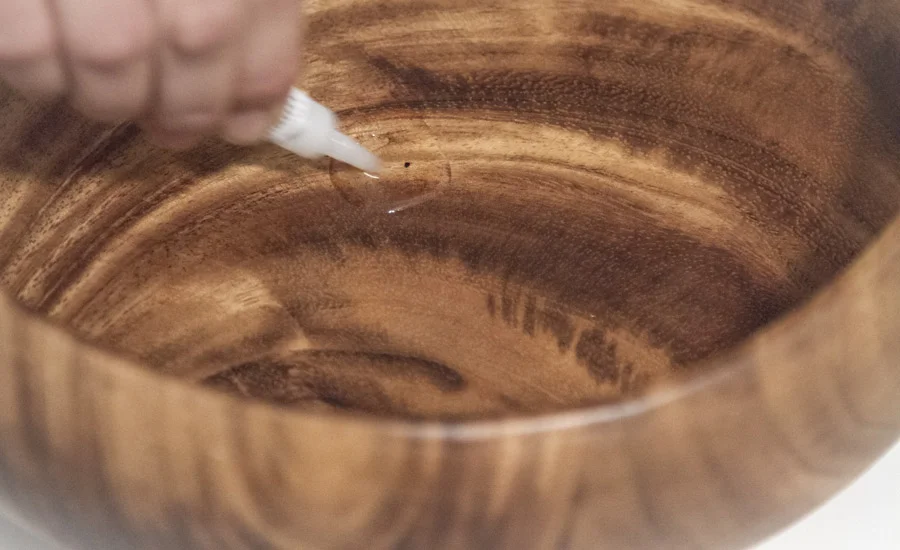 Step 4: Mark the center of the bowl and spread super glue to adhere the paperclip cup