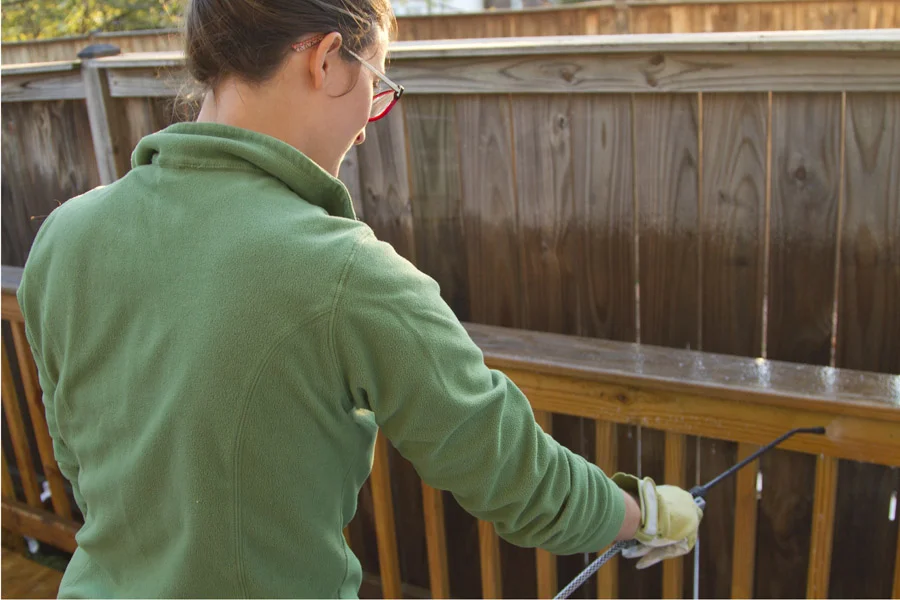 Step 2: Spray Behr Premium all-in-one wood cleaner over the deck