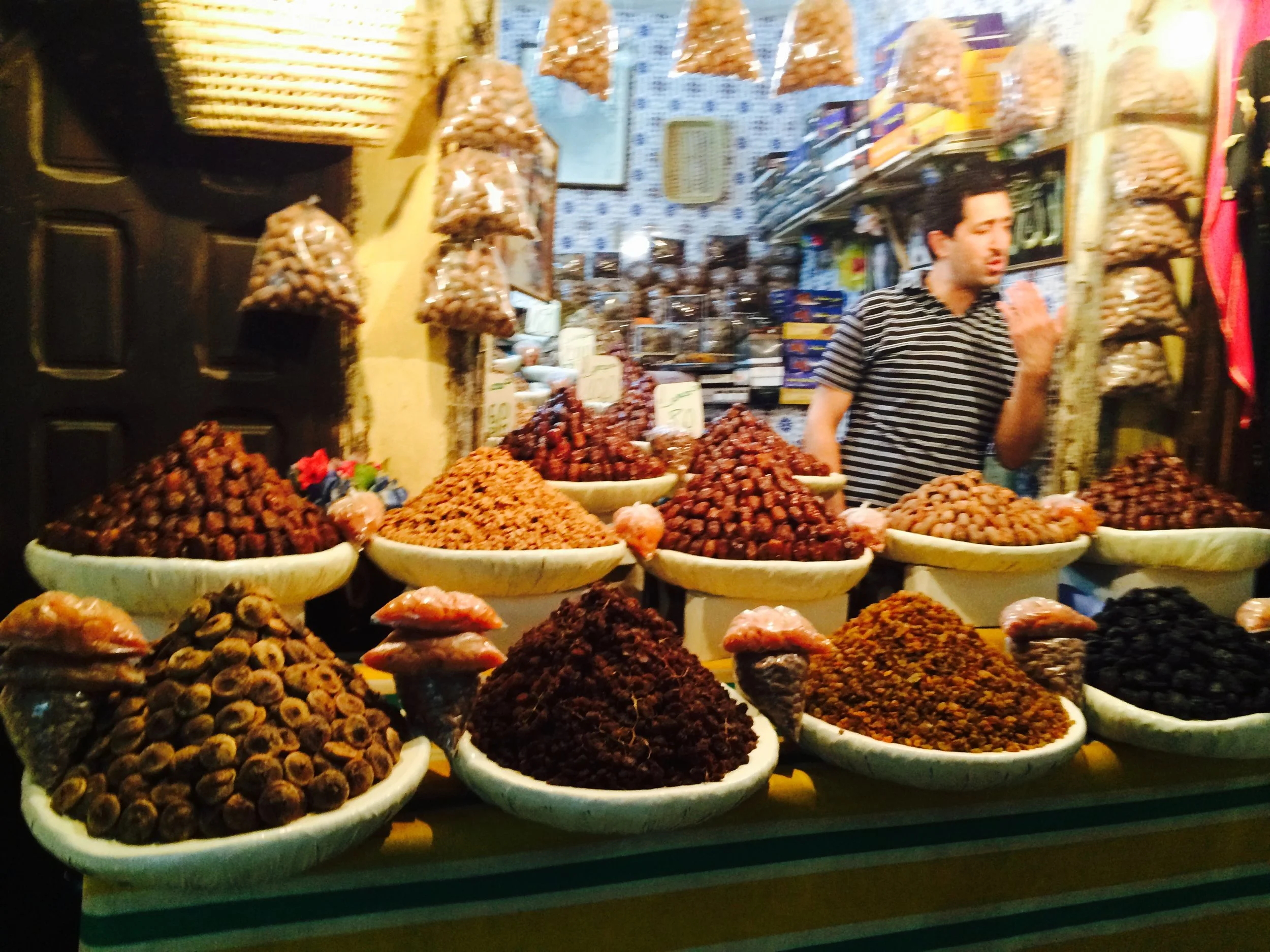 A dried fruit stand with figs, dates, apricots