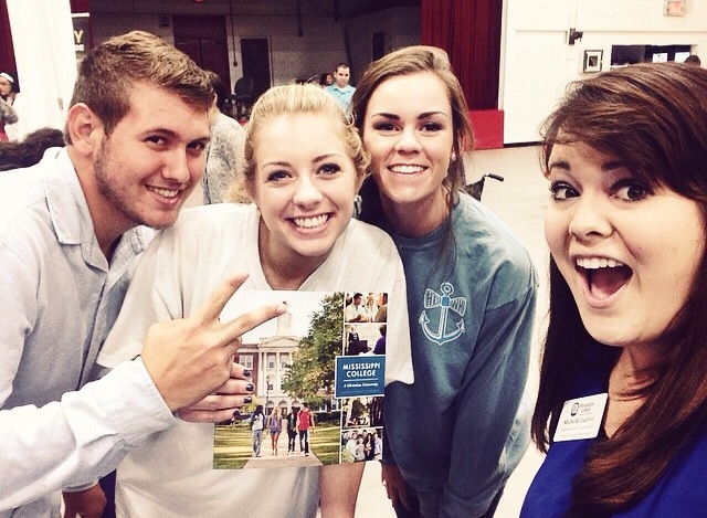 That's a picture of her with some cool kids from a College Fair at Harrison Central High School! 