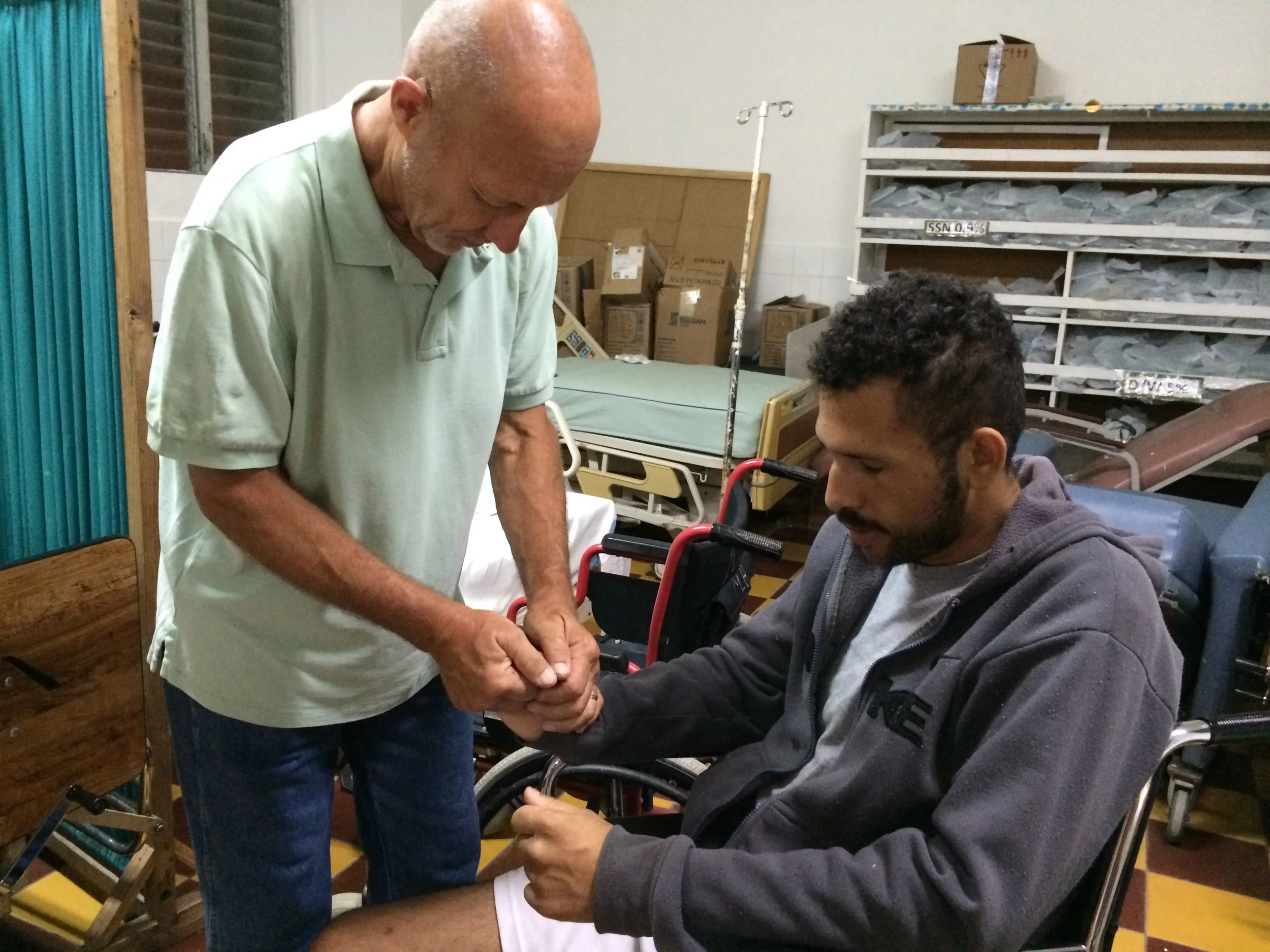 Praying with a man in the hospital in Santa Rosa. We distributed 300 servings of soup and then offered prayers.