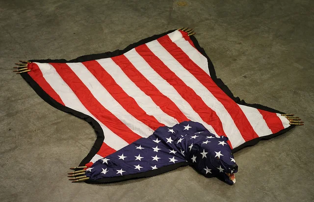 The American Dream Is Alie And Well. Nicholas Galanin. US Flag, felt, .50 Cal Ammunition, Foam, Gold Leaf, Plastic. 2012