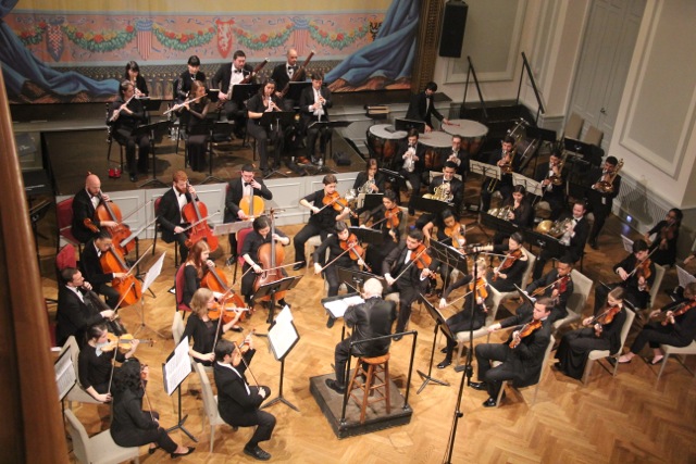 The Aaron Copland School of Music orchestra under the baton of Maestro Peress, in the historic ballroom of the Bohemian National Hall.