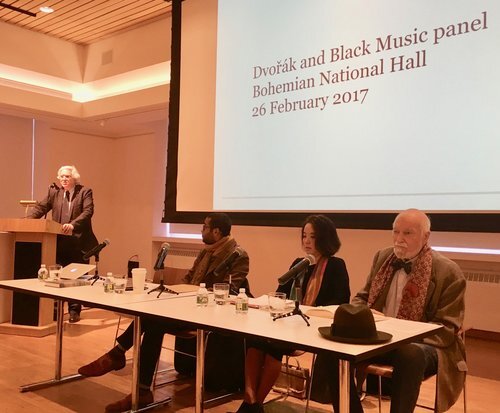 Michael Beckerman at podium; seated left to right, Marcus Pyle, Ellie Hisama, Maurice Peress.