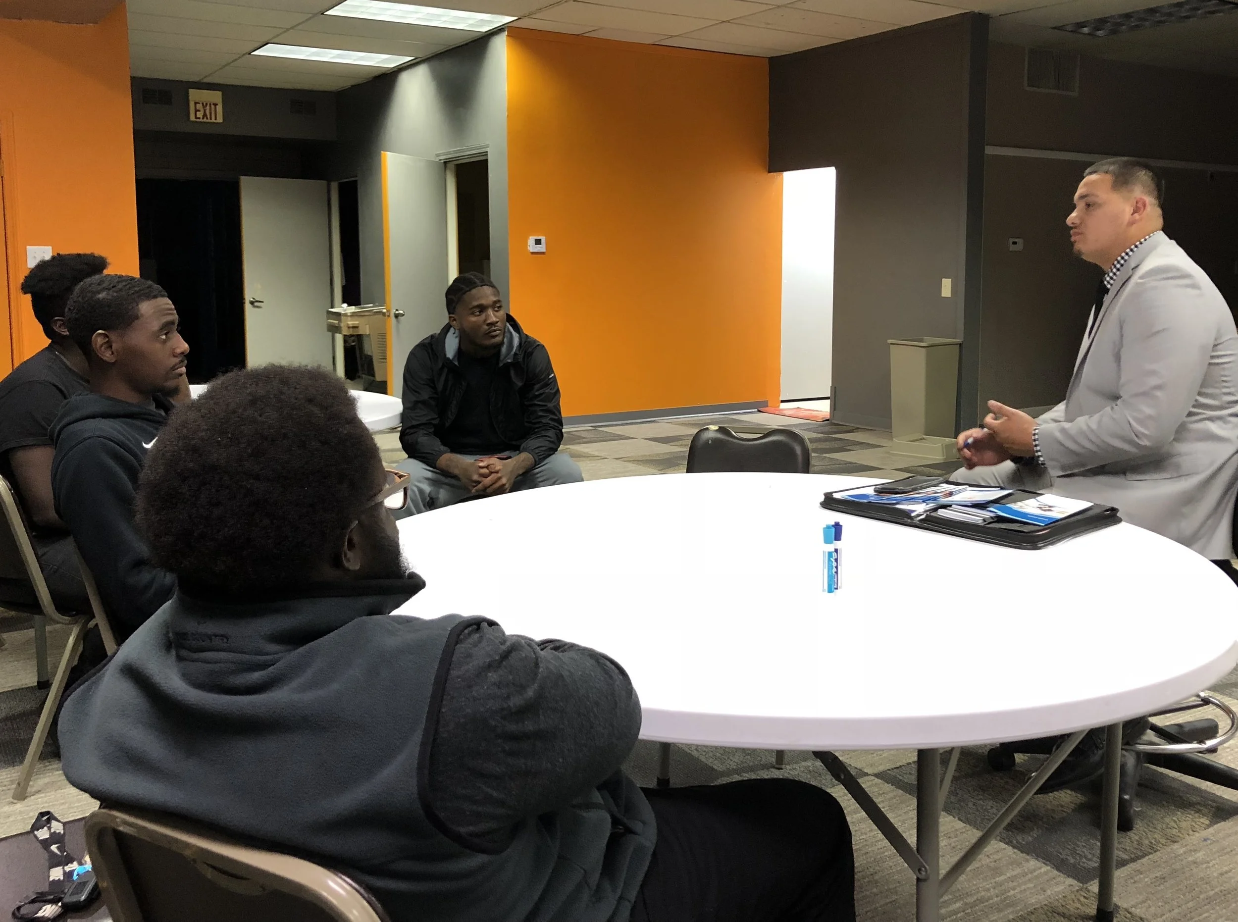 David Rodriguez manager of Lake Michigan Credit Union speaks to the Hustle City Participants about banking