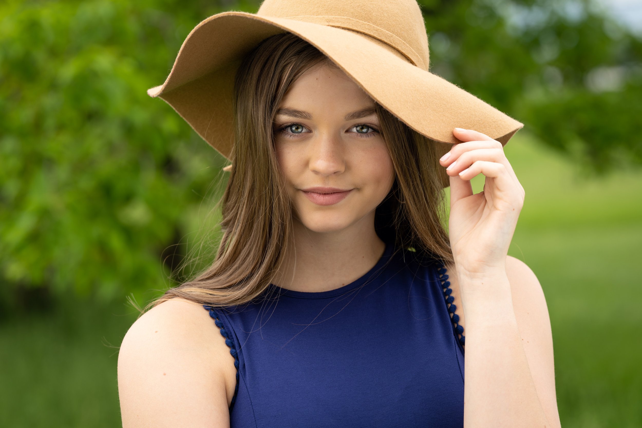 Close-up senior girl with hat outdoors