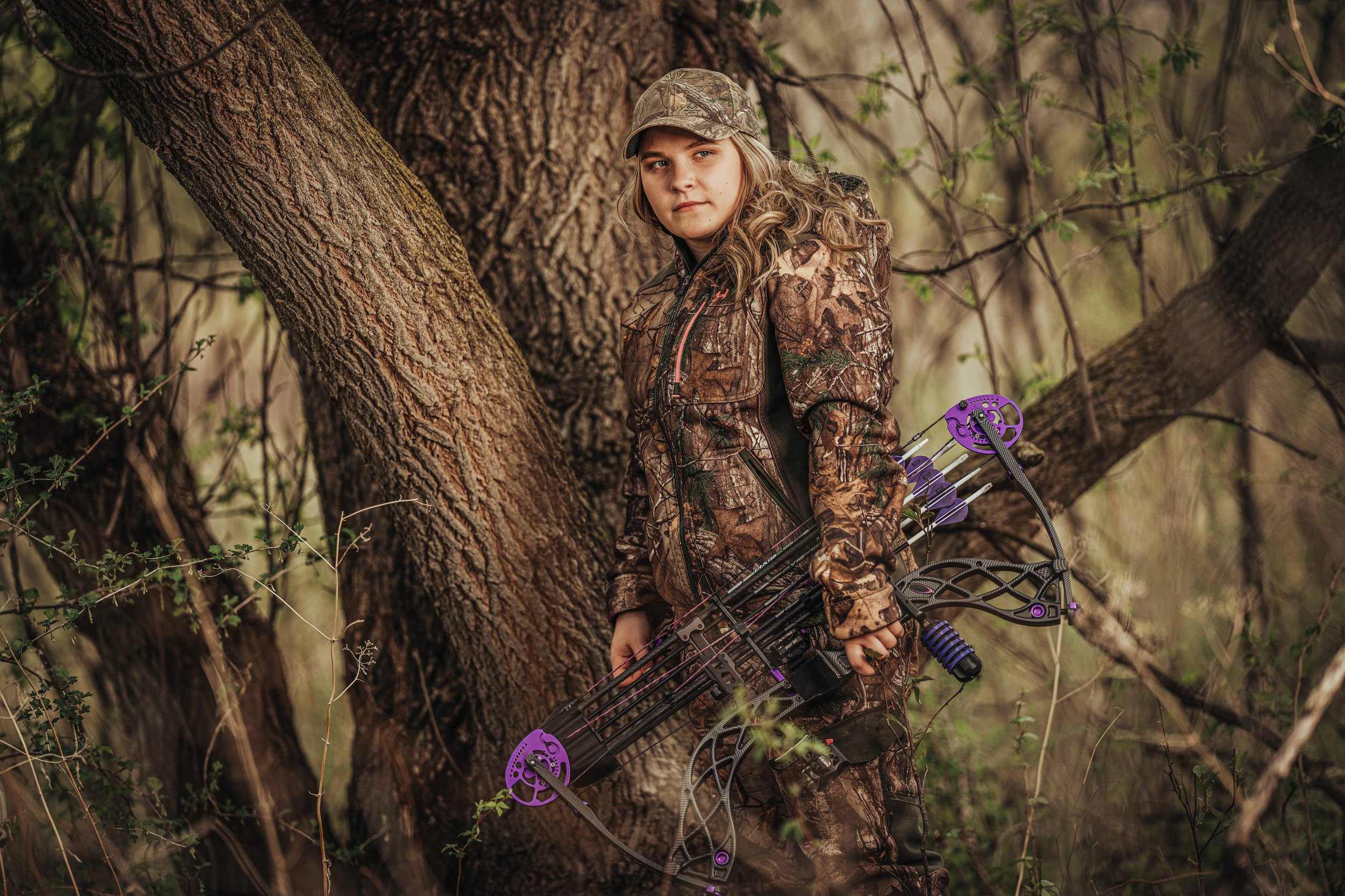 Bow hunting senior girl outdoors