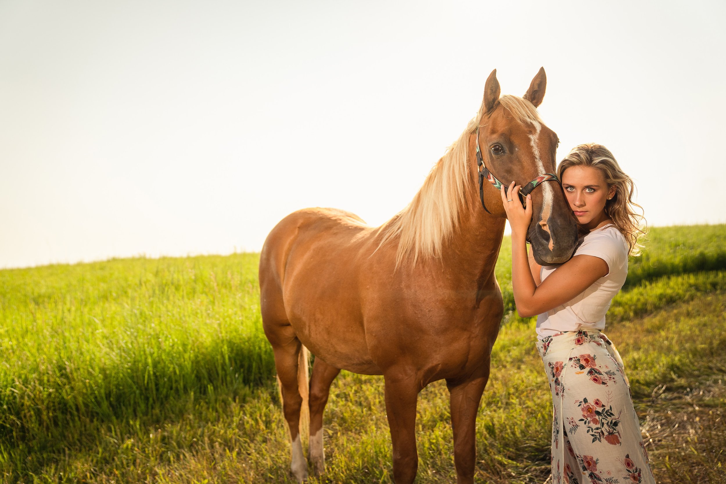 Senior girl with horse in field