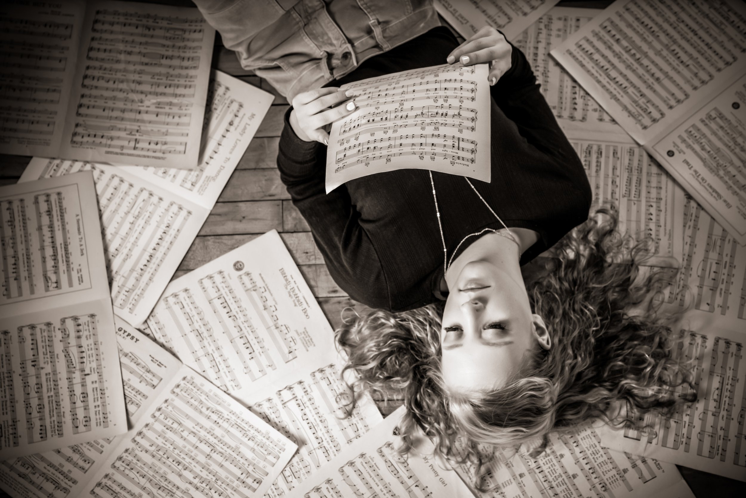 Senior girl surrounded by music sheets