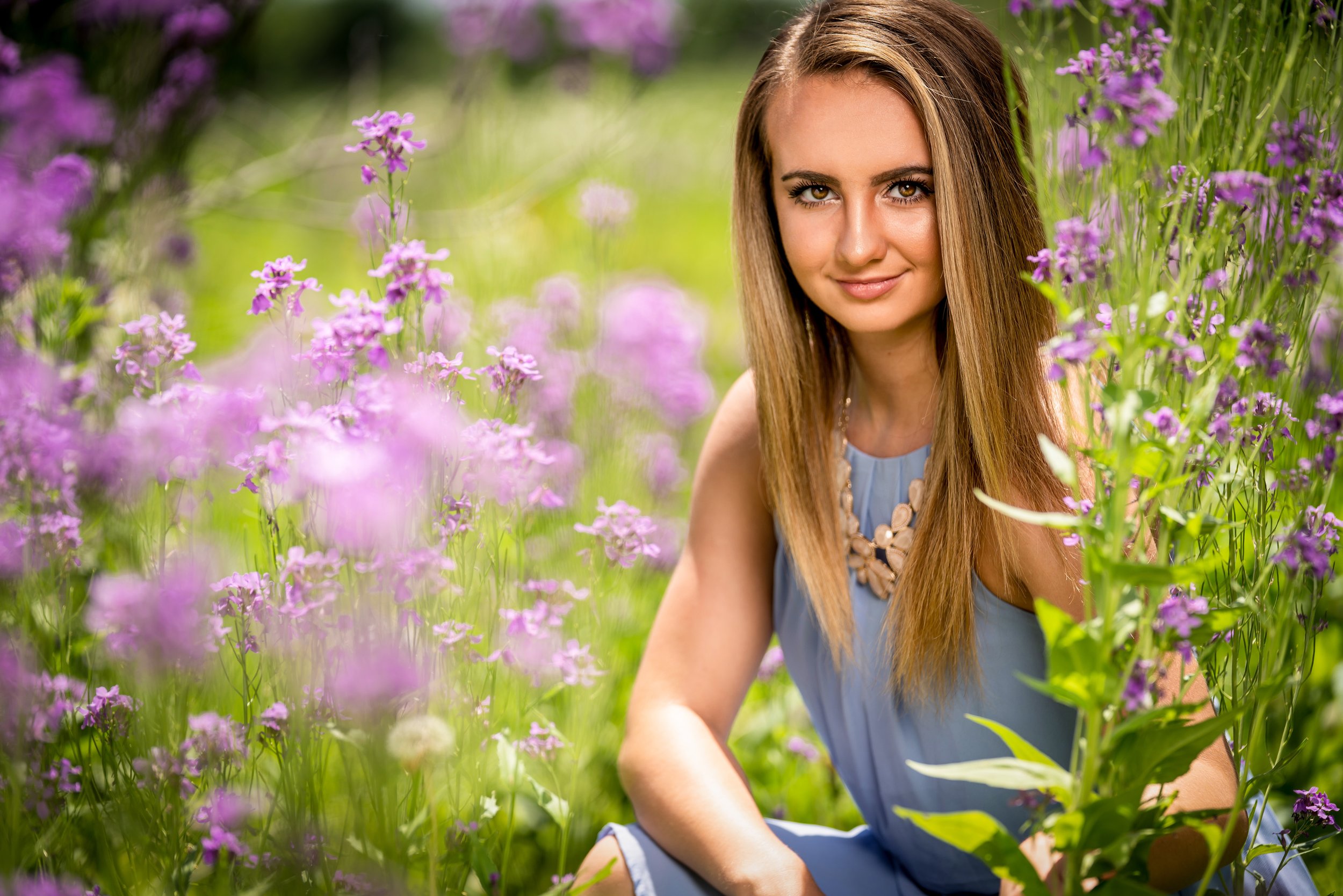 Purple flower field senior girl portrait