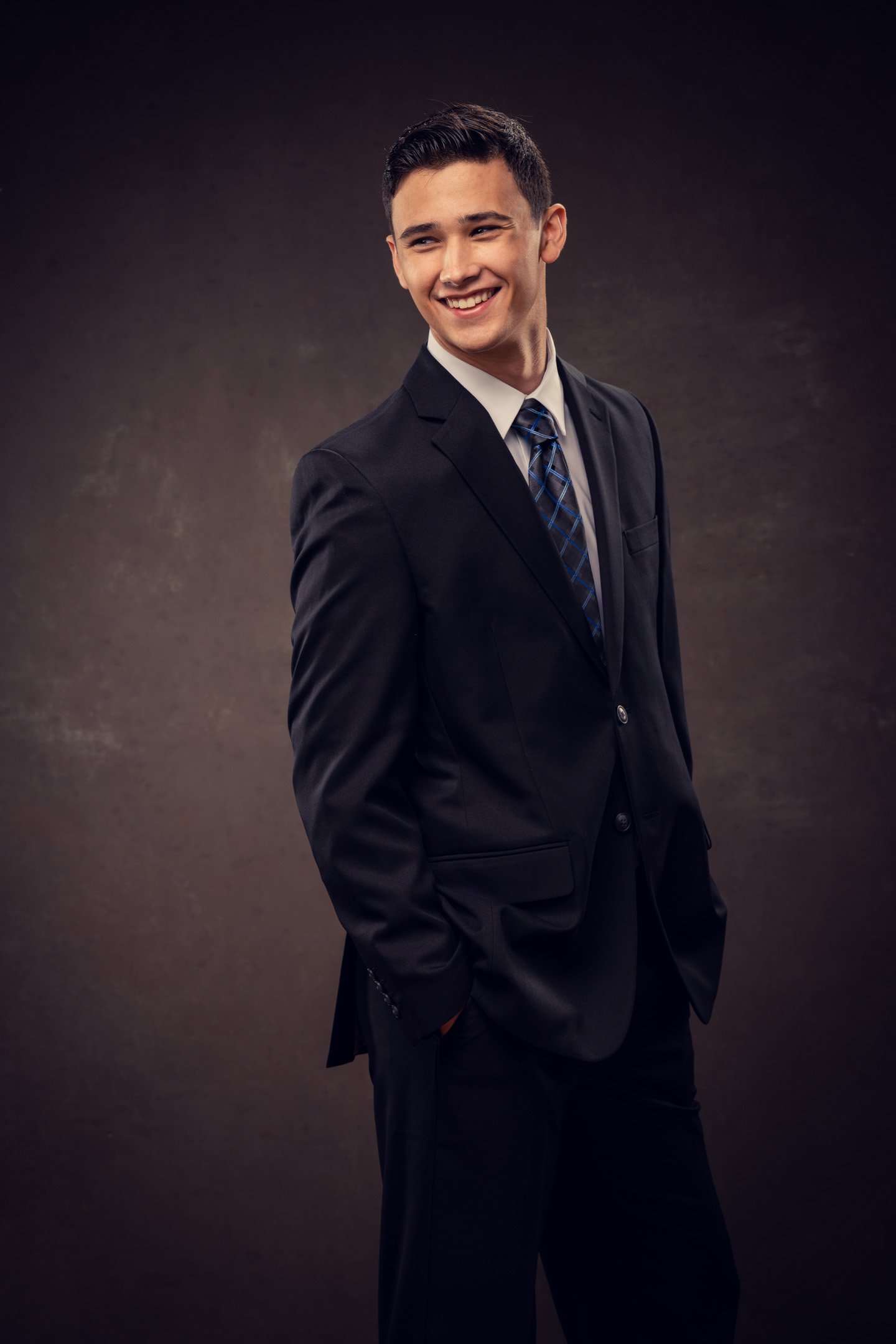 Classic in studio with suit and tie portrait of smiling boy