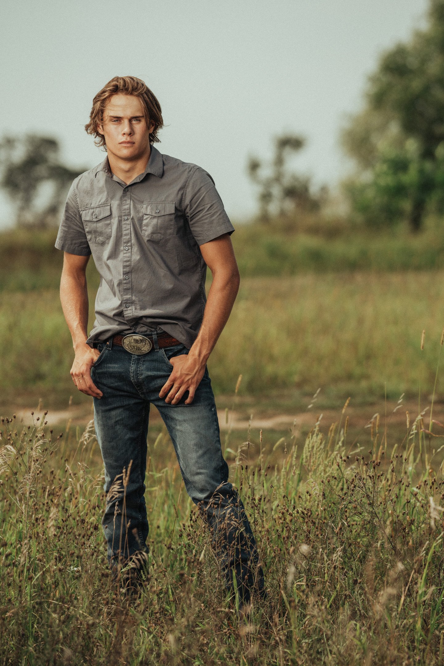 Country boy in field with stern facial expression