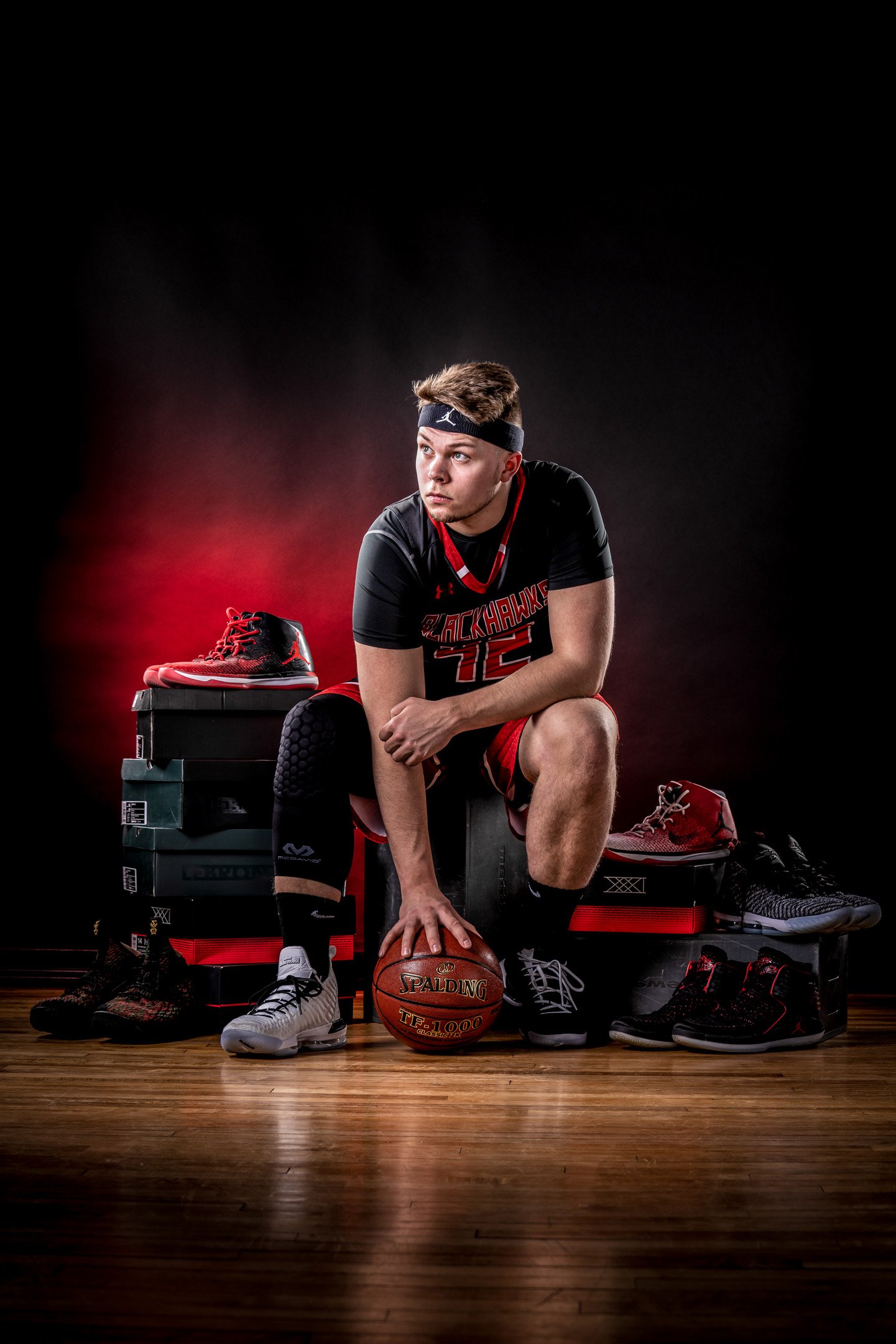 Baldwin basketball player posing with basketball and shoes