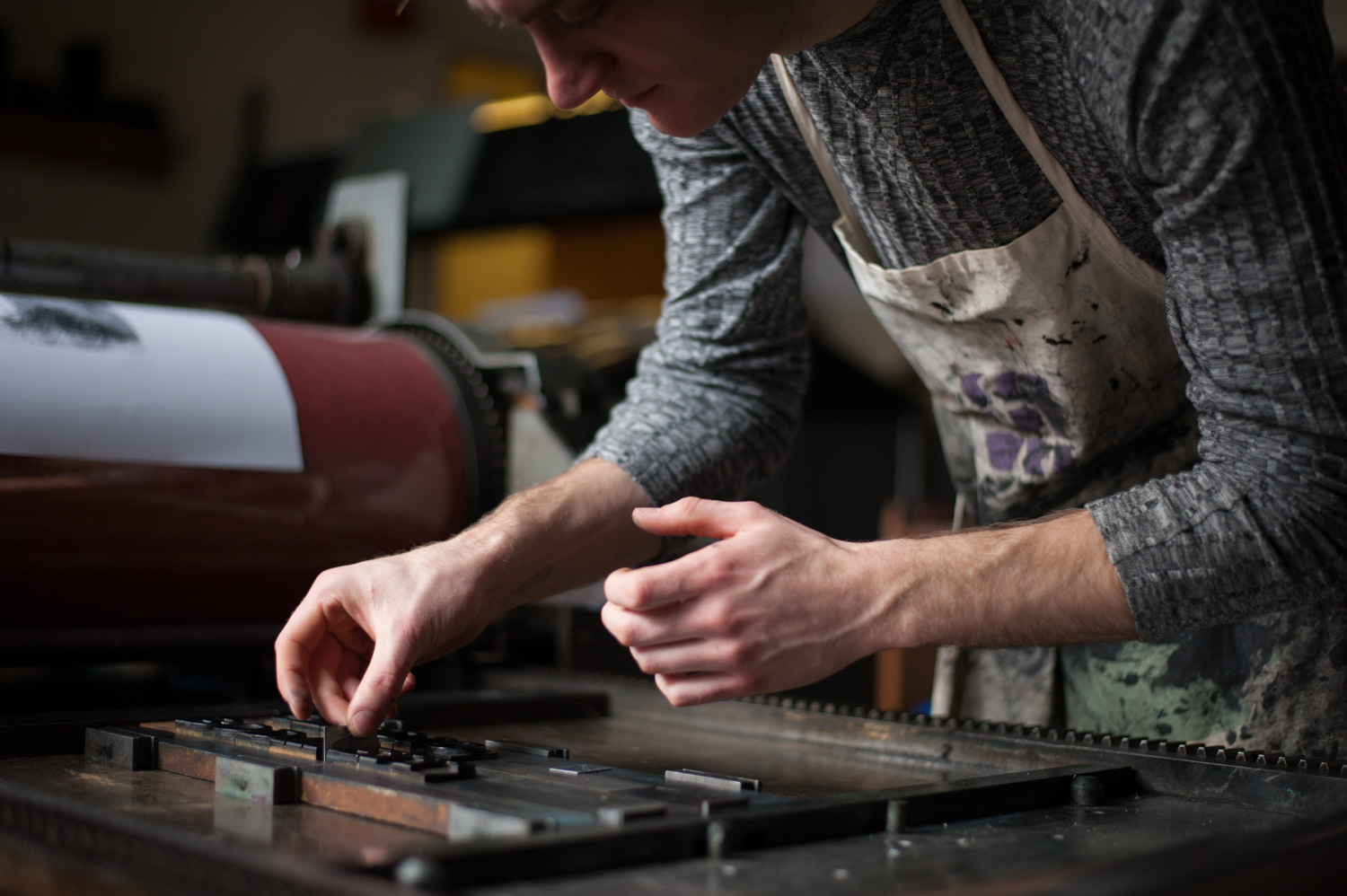 A student screen printing in the Ohio University College of Fine Arts.