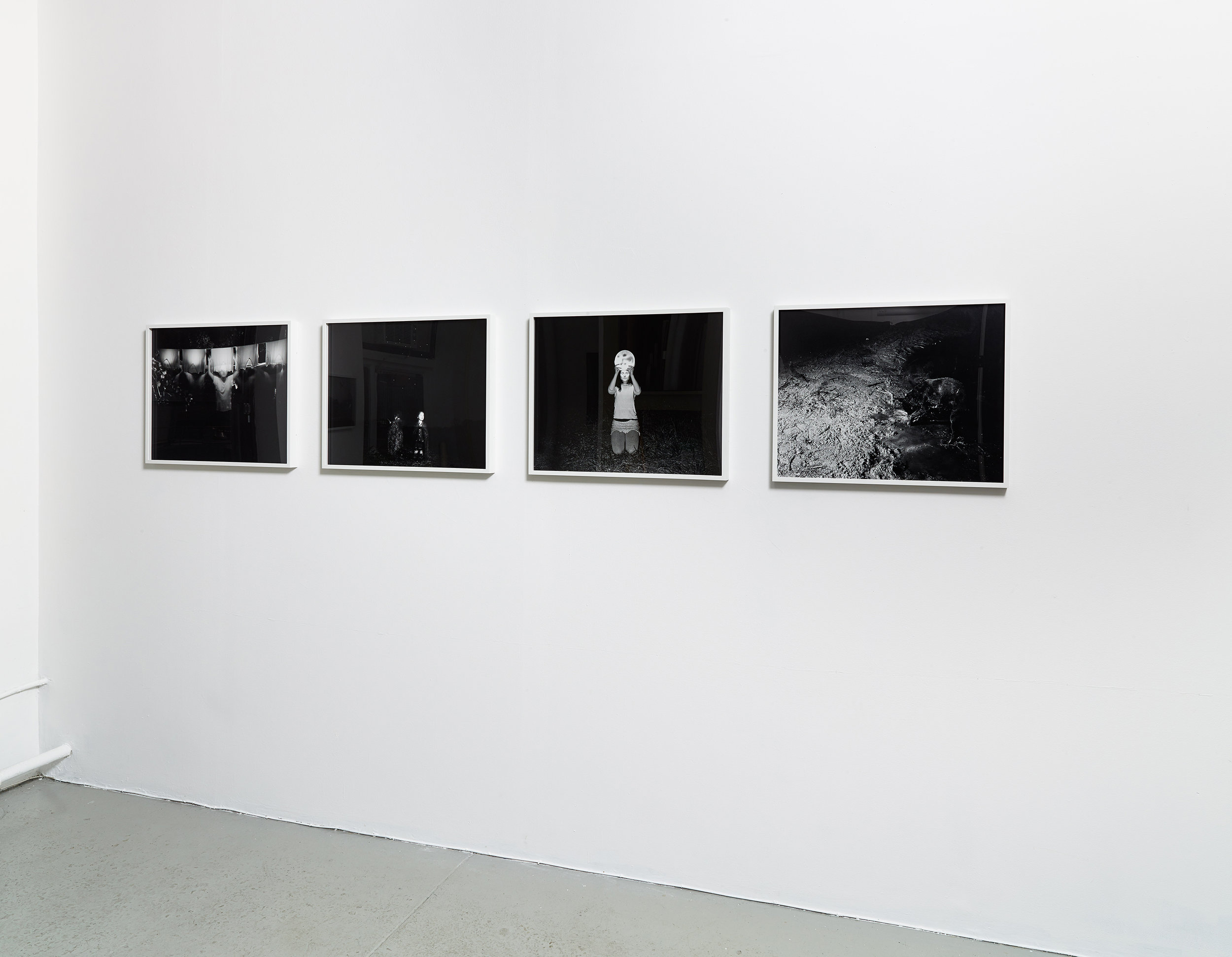 Installation view of black and white photographs by Scott Alario in his solo exhibition ' What We Conjure'