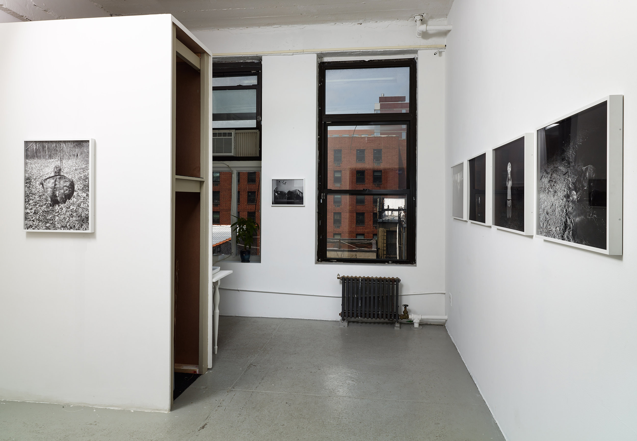 Installation view of black and white photographs by Scott Alario in his solo exhibition ' What We Conjure'