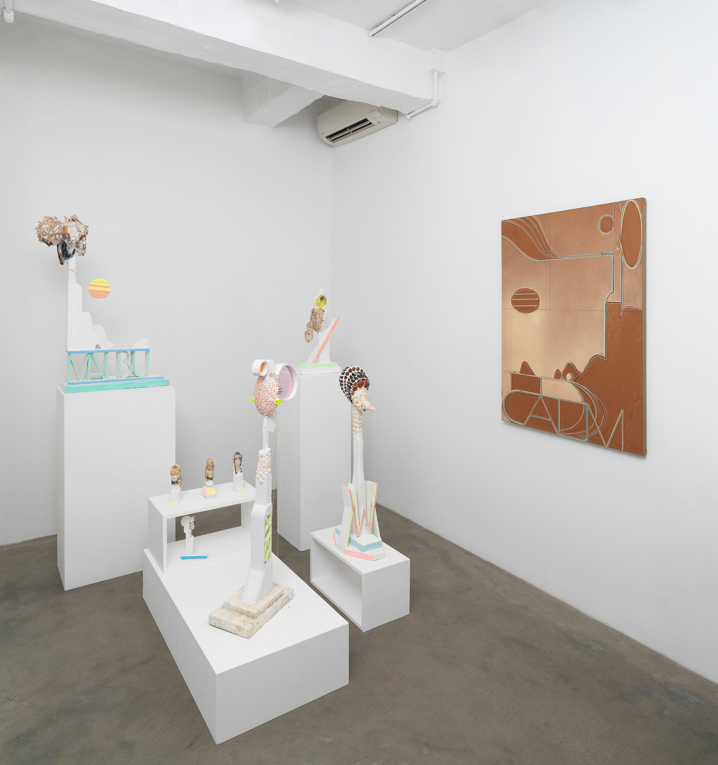 Installation view of Michael Wetzel 'Bu,' showing sculptures made with found shell components and a work made with painted paper attached to stretched linen