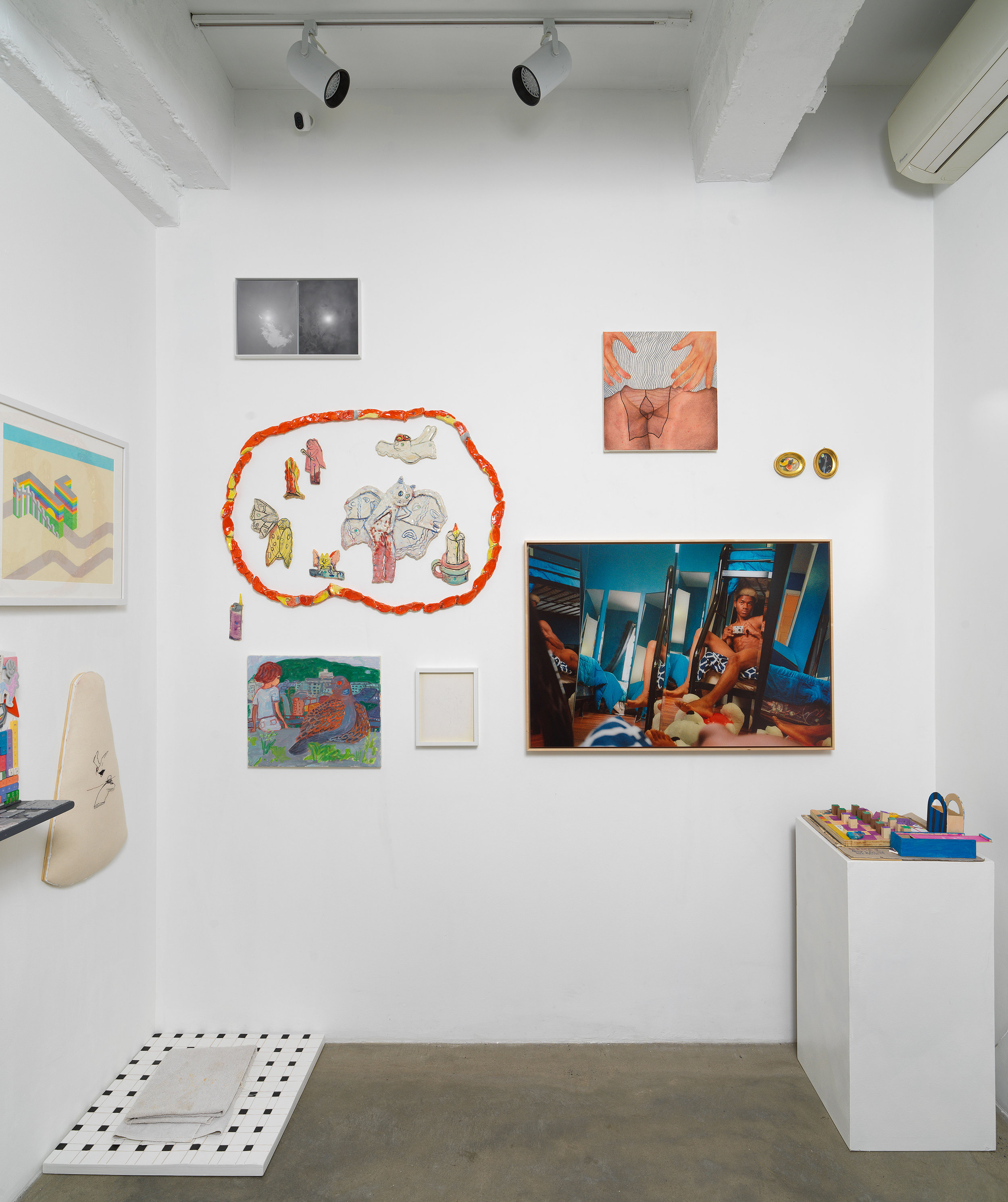 Installation view of 'Can You Dream It' featuring salon-style hanging of multimedia works by various artists, floor and pedesal-based sculpture