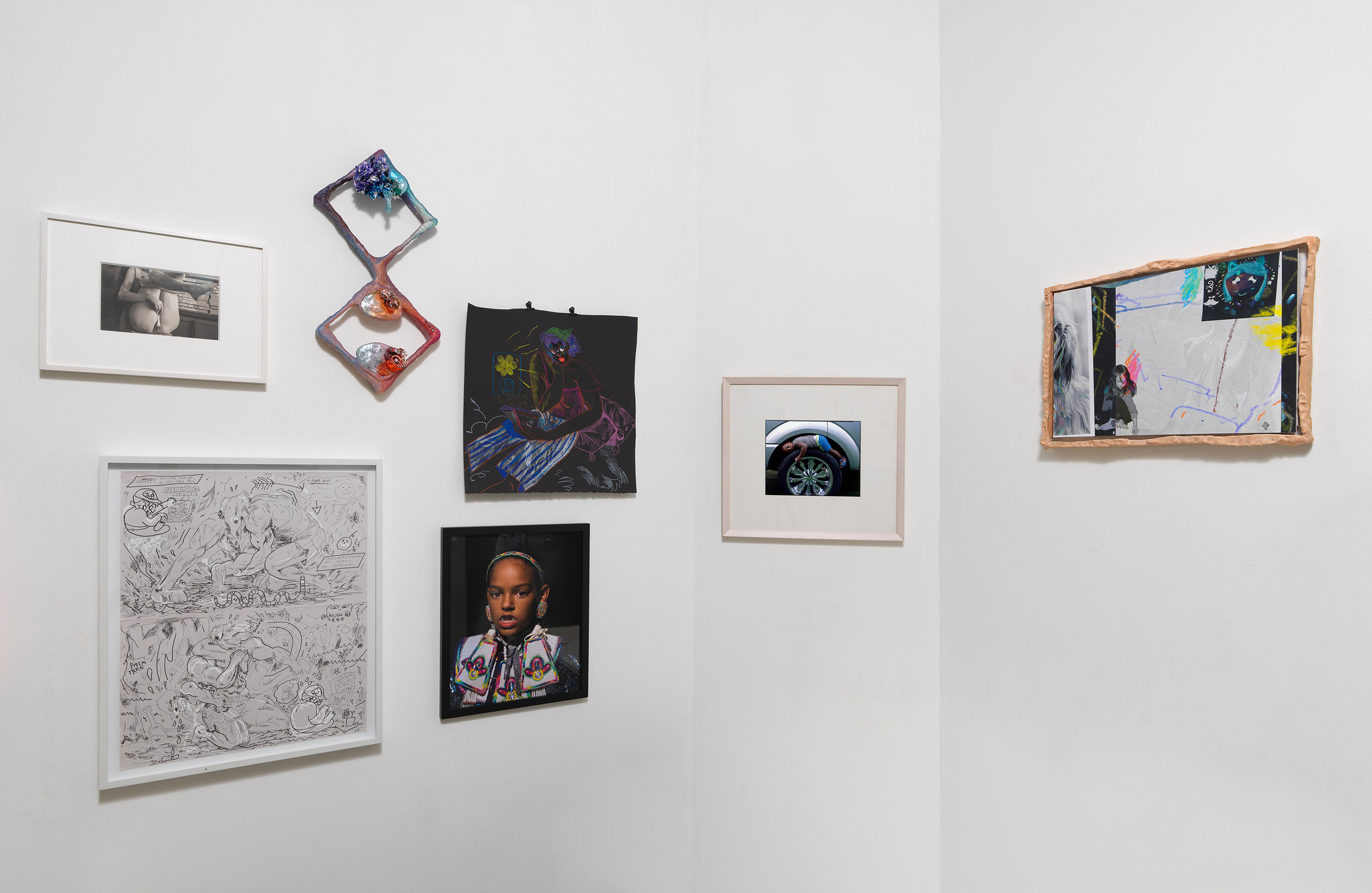 Installation view of 'Can You Dream It' featuring salon-style hanging of multimedia works by various artists