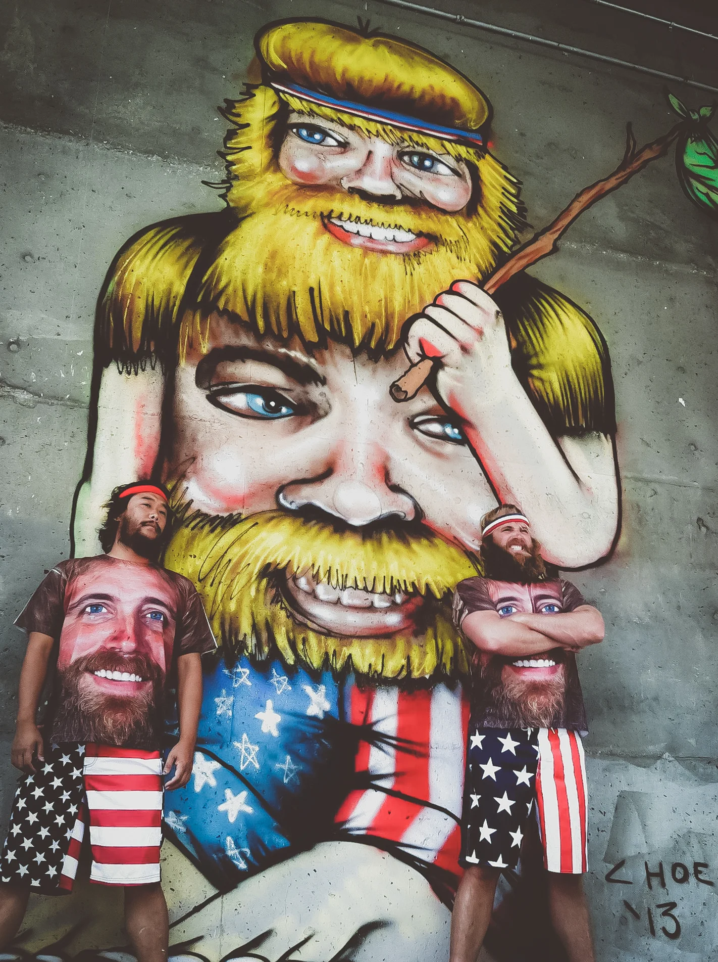  David &nbsp;&amp; Critter in front of a mural of Critter wearing a Critter shirt in Denver 