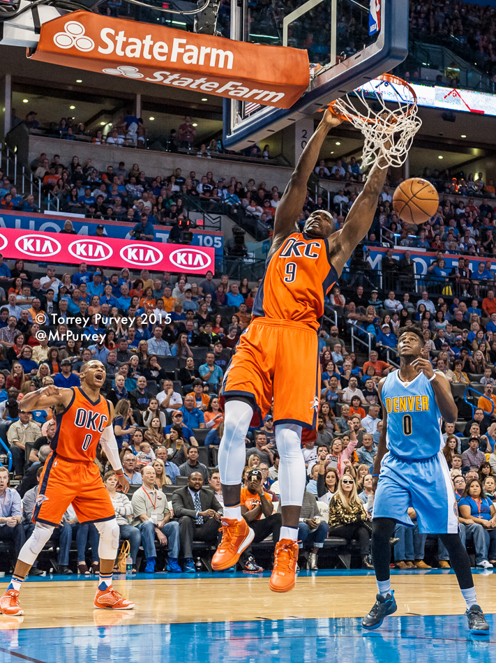 Serge Ibaka (#9) slams home a basket at Chesapeake Energy Arena after a dish from Russell Westbrook (#0). Photo by Torrey Purvey for InsideThunder.com